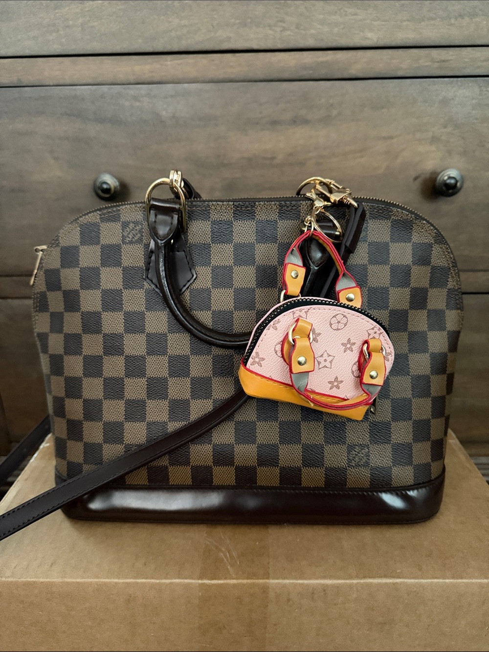 Authentic Louis Vuitton Alma PM with Pink & Yellow Bag Charm